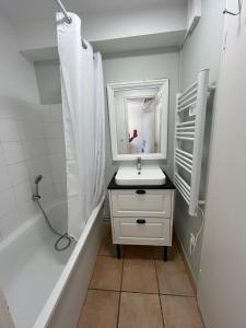 a white bathroom with a sink and a mirror at O'Pale House proche Touquet in Camiers