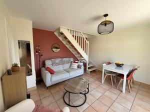 a living room with a couch and a table at O'Pale House proche Touquet in Camiers +17 photos