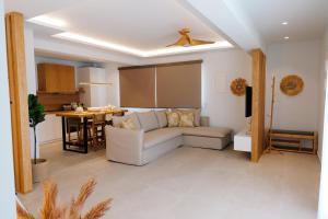 a living room with a couch and a table at Villa Naval in Nea Peramos +52 photos