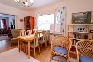 a dining room with a table and chairs at Turvapaikka in Mänttä