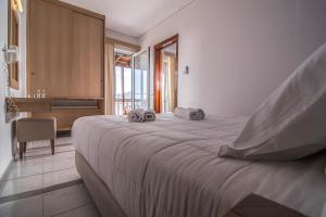 Een bed of bedden in een kamer bij Pal Beach