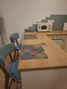 a kitchen with a table with two chairs and a microwave at Apartman JAMI in Spišské Podhradie