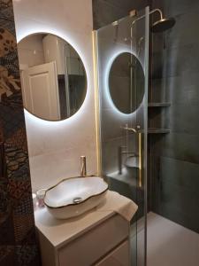 a bathroom with a sink and a mirror at Apartman JAMI in Spišské Podhradie +10 photos