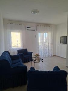 a living room with blue couches and a table at Casa Vacanze Regina in Marsala +11 photos