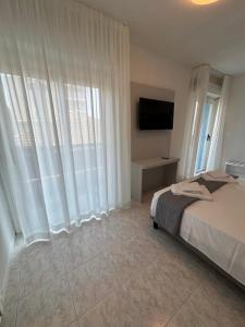 Postel nebo postele na pokoji v ubytování Hotel DOLCEVITA Park & Beach included