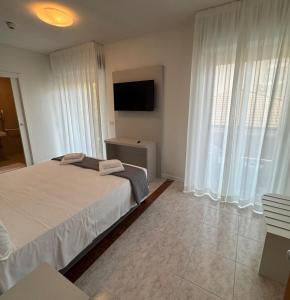 Postel nebo postele na pokoji v ubytování Hotel DOLCEVITA Park & Beach included