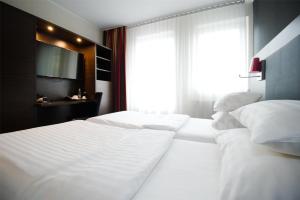 Best Western Plus Plaza Hotel Graz客房内的一张或多张床位