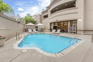 a swimming pool with chairs and a building at Sonesta ES Suites San Antonio Downtown Alamo Plaza - Newly Renovated in San Antonio