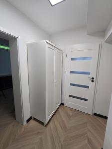 an empty room with a white closet and a door at Szczecinek apartament in Szczecinek
