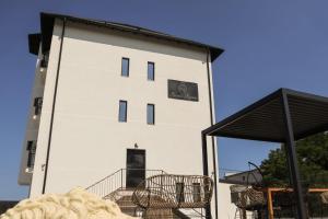 a white building with tables and chairs in front of it at Konac Regesc in Eforie Sud +10 photos