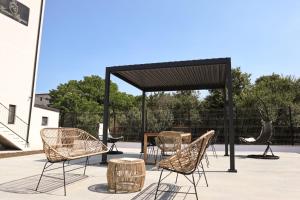 a group of chairs and a table under a pavilion at Konac Regesc in Eforie Sud