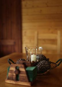 a candle and a bowl of pineapples on a table at Abies Alba in Yarema residence zone