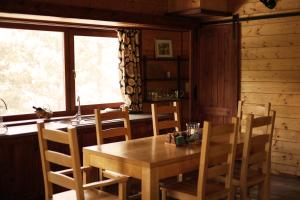 a dining room with a wooden table and chairs at Abies Alba in Yarema residence zone +19 photos