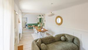 a living room with a couch and a table at La pause en Seine -Wifi in Caudebec-en-Caux