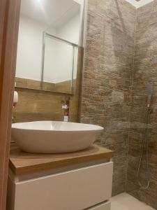 a bathroom with a white sink and a mirror at B&B Airport 26 in Azzano San Paolo