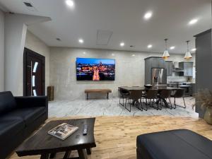 a living room with a couch and a dining room at Coco in Farmington Hills