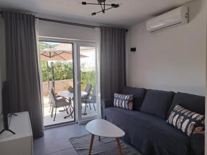 a living room with a couch and a table at Apartments No26 in Povile