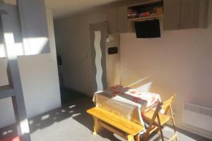 a stack of boxes sitting on a chair in a room at Appart 5 pers, pied des pistes à Piau-Engaly, au coeur de la station in La Celle-sous-Gouzon