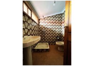 a bathroom with a sink and a toilet at Casa Quixote in Braga