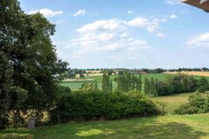 een uitzicht op een veld met bomen en gras bij La Hulotte in Saint-Malon-sur-Mel