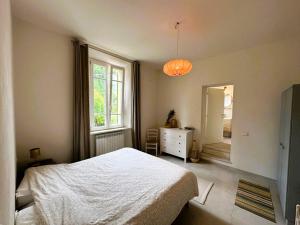 a bedroom with a bed and a dresser and a window at Il Tulipano in Camaiore +9 photos
