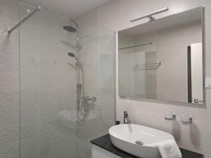 a white bathroom with a sink and a shower at Apartments No26 in Povile +41 photos