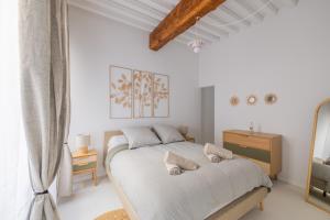 a white bedroom with a bed and a window at Appartement Belle Lettre 7 in Aix-en-Provence