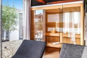 two chairs in a room with sliding glass doors at Luxury Villa Sonia With Wellness & Gym in Labin