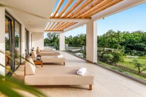 an outdoor living room with couches and windows at Luxury Villa Sonia With Wellness & Gym in Labin