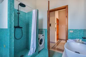 a bathroom with a shower and a washing machine at Appartamento Anita in Lucca +7 photos
