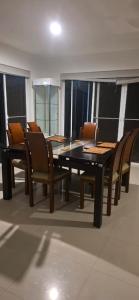 a dining room with a black table and chairs at Hermosa casa para vacaciones in Flandes