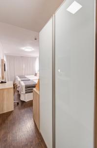 Cama ou camas em um quarto em Allia Gran Pampulha Suites