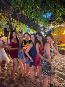 a group of people posing for a picture on the beach at Hakuna Matata Seaside Escape in Arambol +2 photos