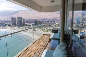 a balcony of a building with a view of a city at Terrado Suites Iquique in Iquique