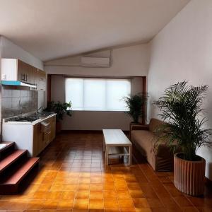 a kitchen and living room with a couch and a table at Casa Carmesí in Oaxaca City