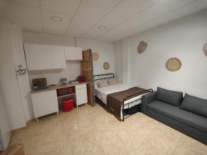 a small room with a bed and a couch at El Rincón Coqueto in Pinoso +7 photos