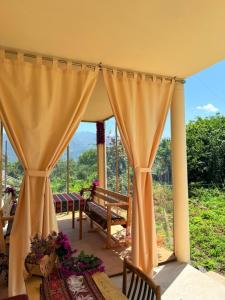 a room with a table and a curtain at JIV Guesthouse in Odzun in Odzun