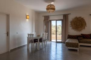 a living room with a table and chairs and a couch at Kaouki Zen Lodge in Essaouira