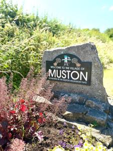 a sign for welcome to the village of musion at Autumn Cottage in Filey
