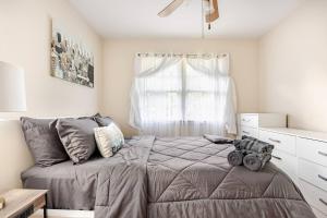 a bedroom with a bed and a window at 3BR Home - Free Parking-WiFi Kitchen Laundry-Kids Friendly-Near DC & Downtown & Metro-Patio & Deck in Falls Church