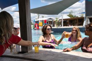a group of women sitting around a pool drinking beer at Lagoon Ranch RV Resort in Onalaska
