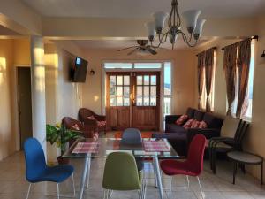 a living room with a couch and a table and chairs at Scotland Villa-Dominica in Canefield