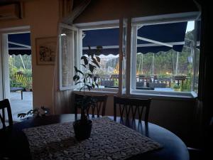 a dining room with a table and a window at Wine Garden old apartment in Skradin