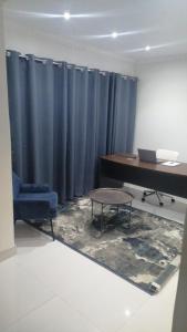 an office with a desk and a blue curtain at VillaDelux in Pretoria