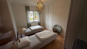 a room with two beds and a chandelier at Alsterfors 23 