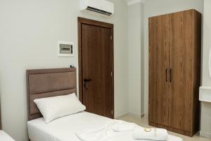 Postel nebo postele na pokoji v ubytování OLI Hotel