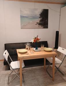 a dining room table with two chairs and a couch at PitStop 6 in Tampere