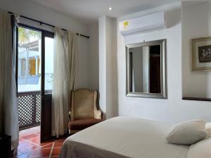 Postel nebo postele na pokoji v ubytování Hotel Casa de Las Palmas