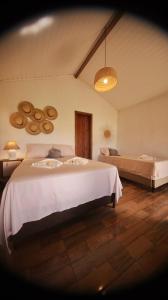 a bedroom with two beds in a room at Vila Ohana Beira Mar - Xandó-Caraíva in Caraíva