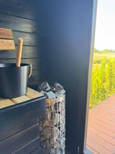 a trash can sitting next to a wall with a window at Green Field Villa in Kuressaare +41 photos